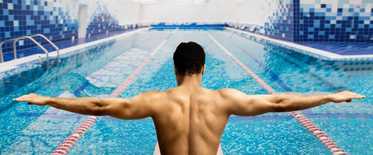 man preparing to swim indoors